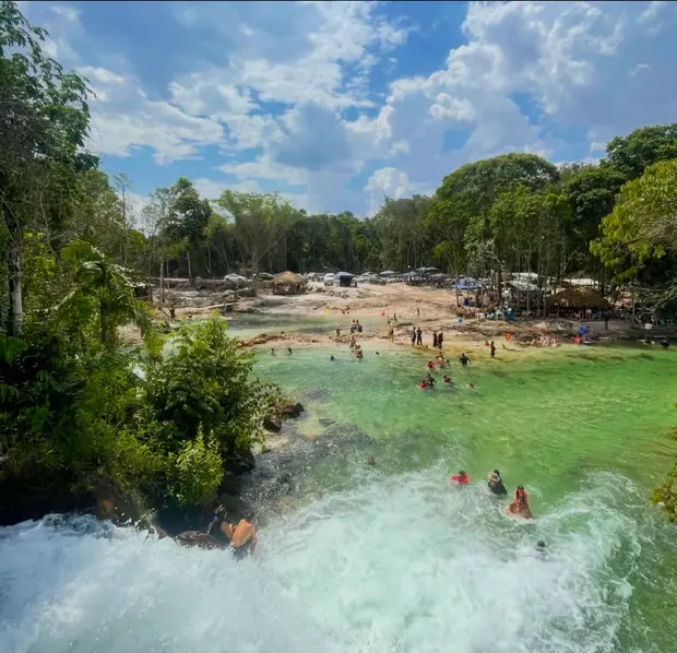 Cachoeira e água verde da Ilha das Orquídeas, com banhistas